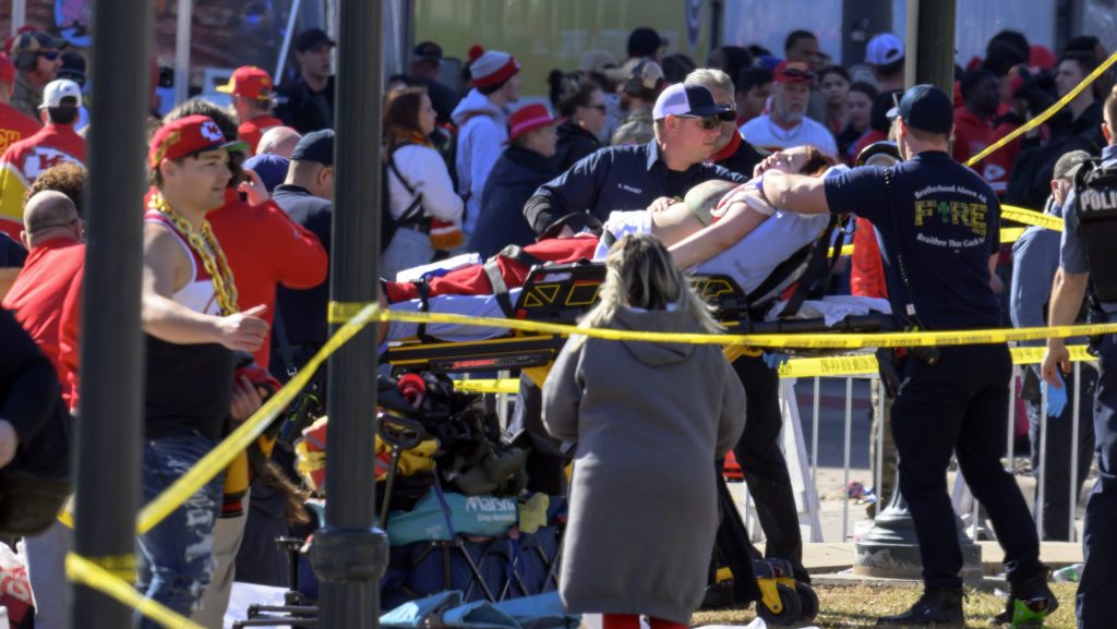 A woman is taken to an ambulance after an incident following the Kansas City Chiefs NFL football Super Bowl celebration in Kansas City, Mo., Wednesday, Feb. 14, 2024.