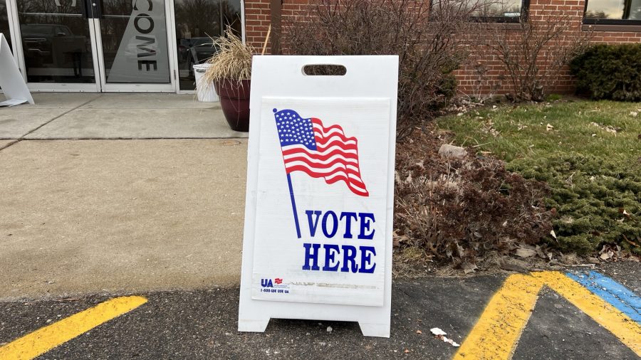 A sign that says "Vote Here"