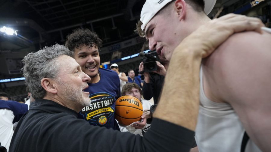 Oakland University coach Greg Kampe, left, talks with guard Blake Lampman after the team's win over Milwaukee in an NCAA college basketball game for the championship of the Horizon League men's tournament in Indianapolis, Tuesday, March 12, 2024.