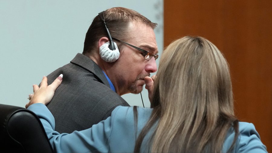 Defense attorney Mariell Lehman puts her arm on James Crumbley after he gets emotional after watching the video of his son walking through the halls of Oxford H.S. in a video shown in the Oakland County courtroom Friday, March 8, 2024, in Pontiac, Mich.