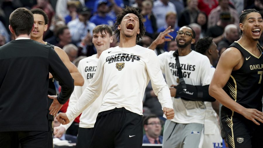 Oakland players celebrate after defeating Kentucky in a college basketball game in the first round of the men's NCAA tournament Thursday, March 21, 2024, in Pittsburgh.