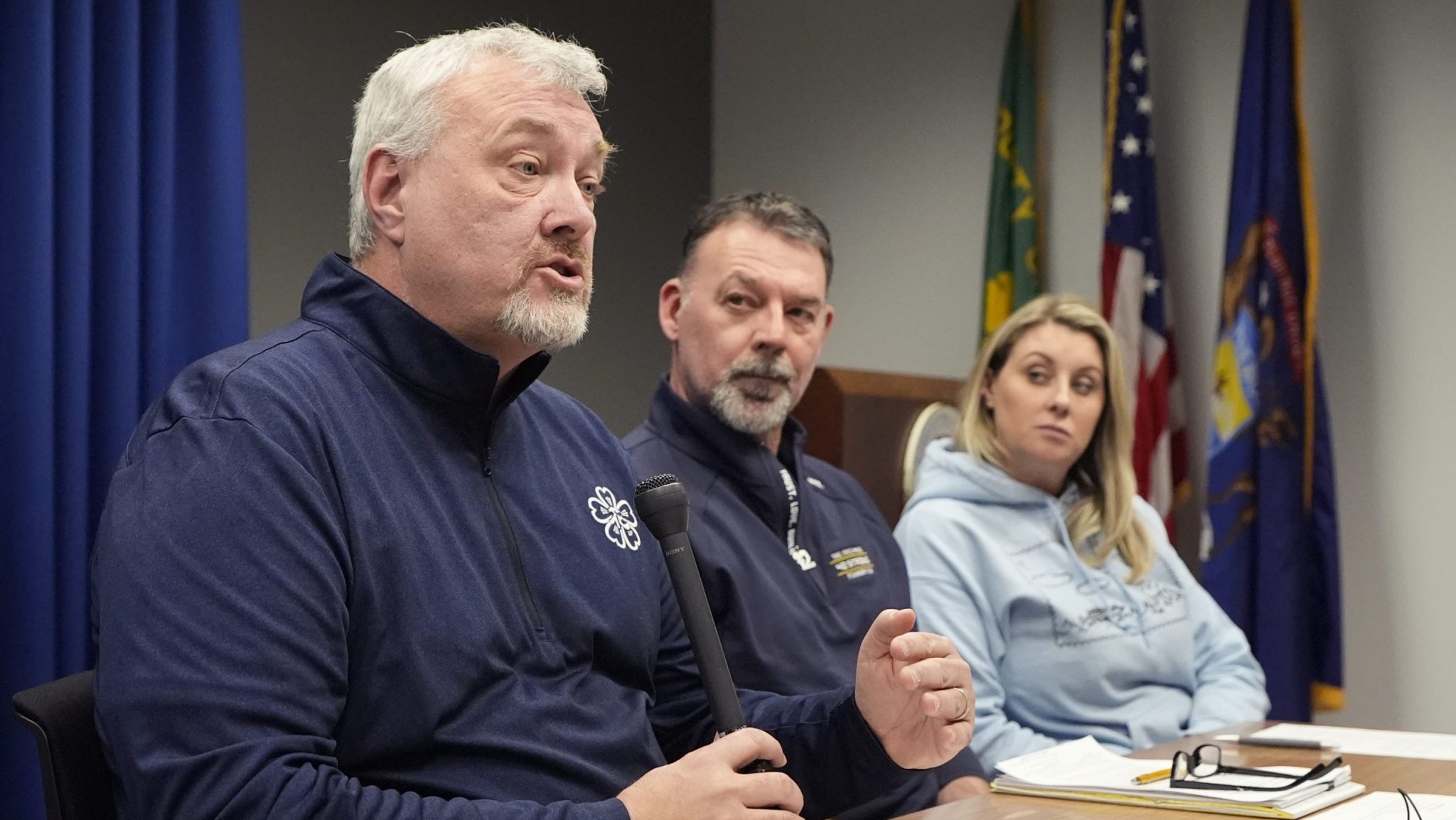 The parents of four students killed in a shooting in Michigan more than two years ago are interviewed Monday, March 18, 2024 in Pontiac, Mich. From left, Steve St. Juliana, Buck Myre and Nicole Beausoleil called for a state investigation of all aspects of the 2021 mass shooting, saying a local criminal probe that netted three is not enough to close the book.