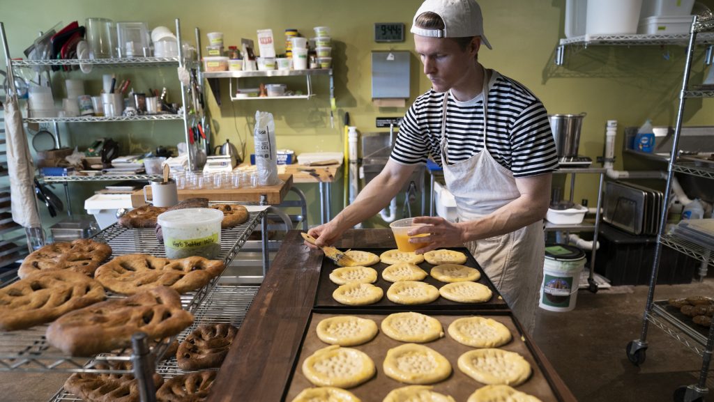 Maxwell Leonard applies an egg wash to a pastry at his shop There is No Secret Bakery located at 821 Livernois Street in Ferndale on Wednesday, Feb. 7, 2024.