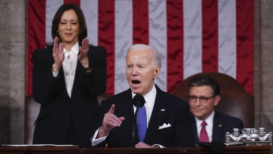 President Joe Biden delivers the State of the Union address to a joint session of Congress at the Capitol, Thursday, March 7, 2024, in Washington. Standing at left is Vice President Kamala Harris and seated at right is House Speaker Mike Johnson, R-La.