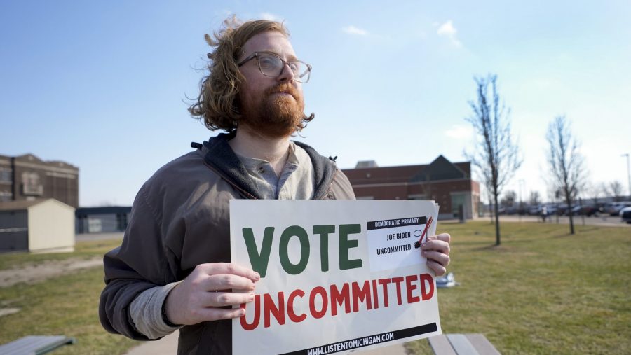 Eric Suter-Bull holds a Vote Uncommitted sign outside a voting location at Saline Intermediate School for the Michigan primary election in Dearborn, Mich., Tuesday, Feb. 27, 2024. Michigan is the last major primary state before Super Tuesday and a critical swing state in November's general election.