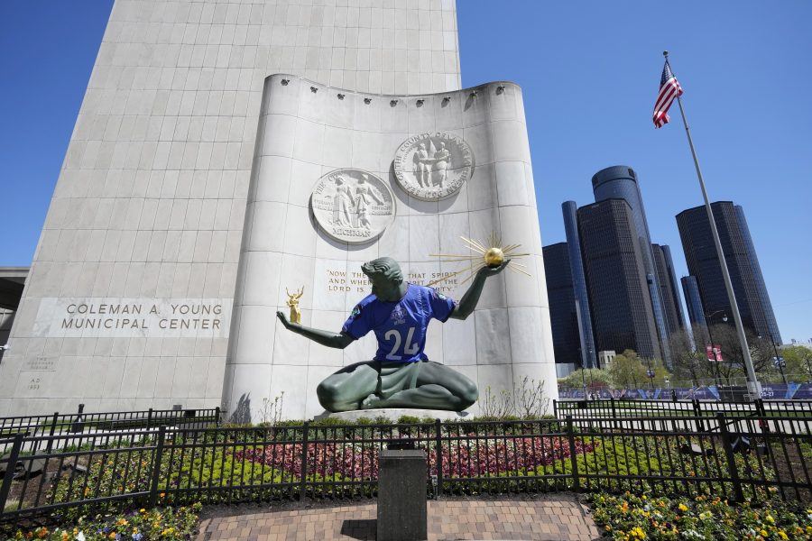 An NFL football draft jersey is displayed on the Spirit of Detroit statue