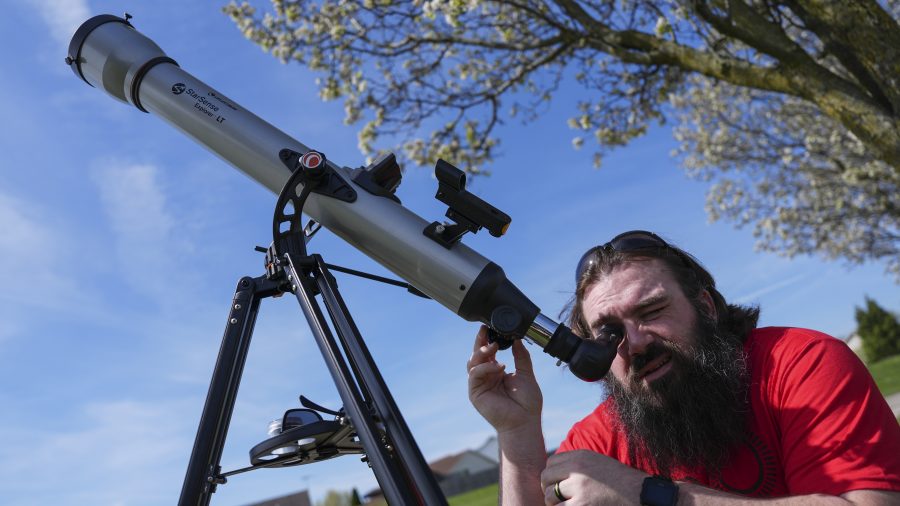 Kenny Riehl, of Solon, Iowa, adjusts a telescope while looking at the sun before a total solar eclipse, Monday, April 8, 2024, in Trenton, Ohio.