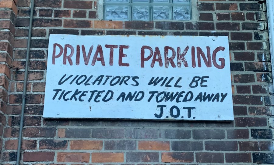 Sign that reads, "Private Parking. Violators will be ticketed and towed away. J.O.T."