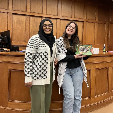 Law students Raisa Faatimah , left, and Caitlin Doolittle at the community Iftar they organized for the Day of Hunger Solidarity for Gaza at Michigan Law School.