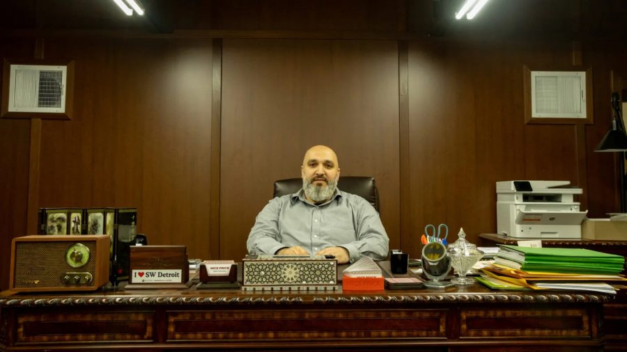 Ahmad Al-Hasan, owner of Nice Price, poses å at his desk.