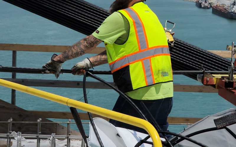 A construction worker does his job on the Gordie Howe Bridge deck.