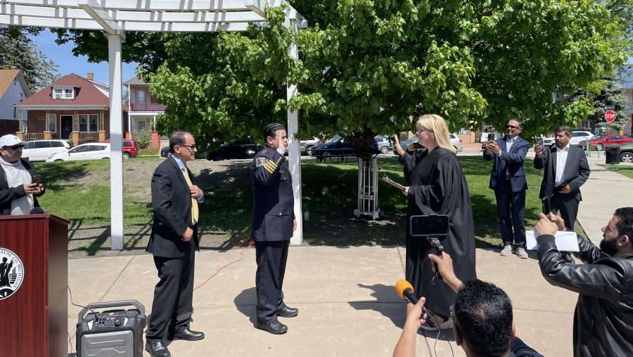 The new Hamtramck Police Chief Jamiel Altaheri was sworn on May 13, 2024, in front of city hall among a crowd of about 50 onlookers, and with his father behind him.