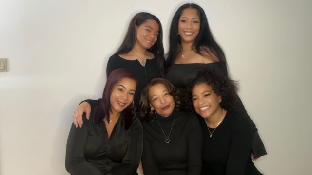 Diane Sanders (center), manager of strategic initiatives at WDET, poses with her four daughters.