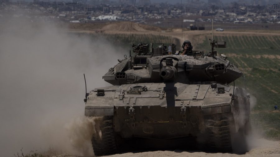 Israeli soldiers move on the top of a tank near the Israeli-Gaza border, as seen from southern Israel, Thursday, May 16, 2024.
