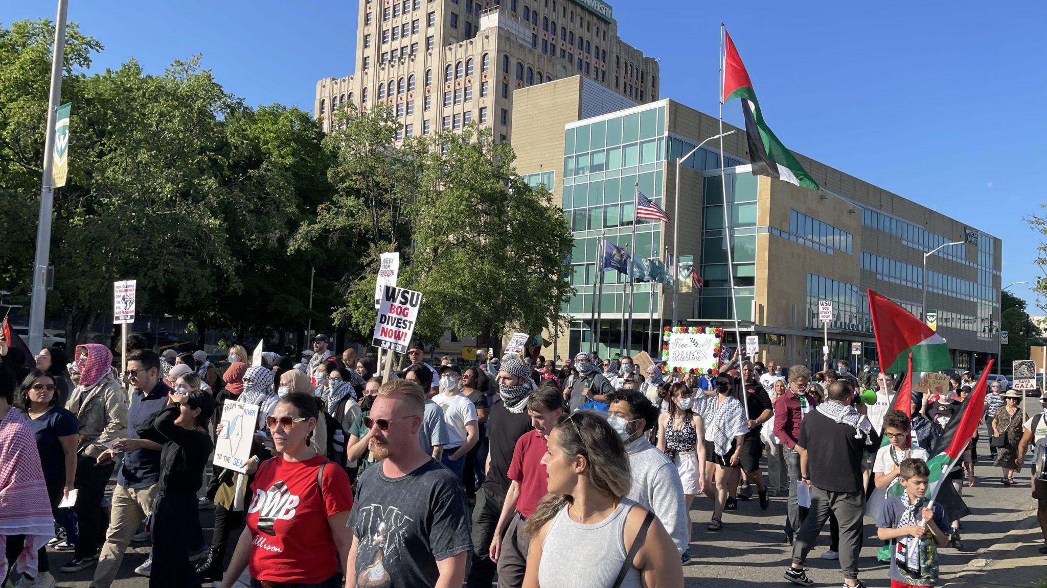 Pro-Palestinian protesters march in front of Wayne State University's Welcome Center along Warren Avenue in Detroit on May 23, 2024.