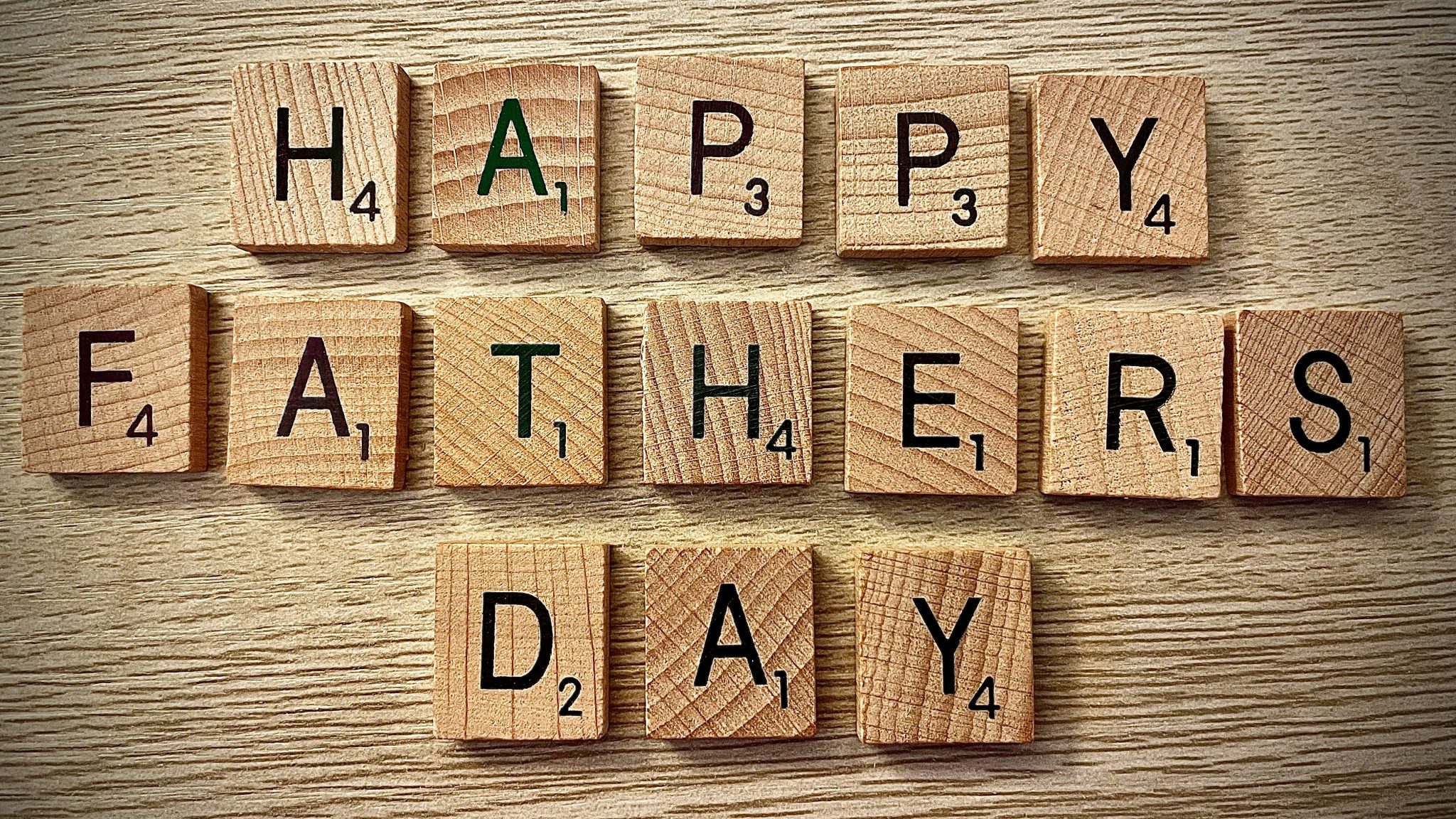 Wooden blocks with letters printed on them that spell out happy fathers day