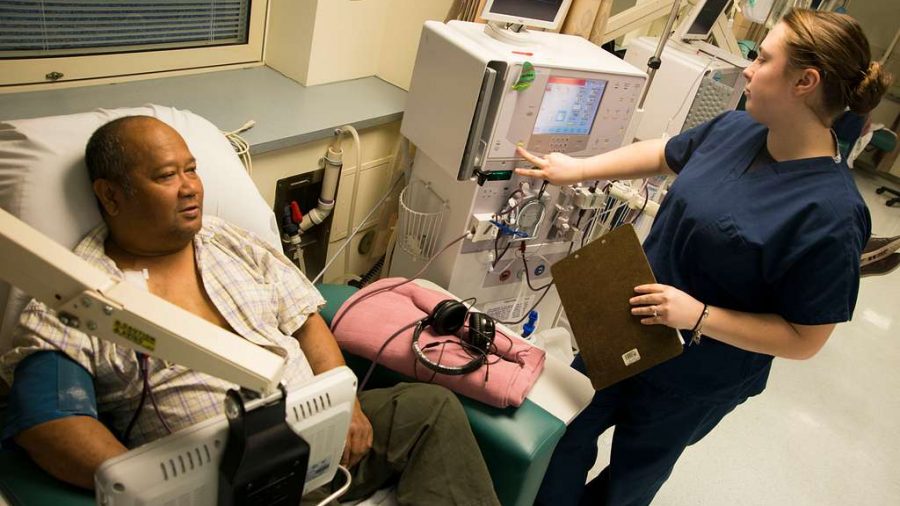 FILE - A hemodialysis technician monitors the dialysis machine of a patient.