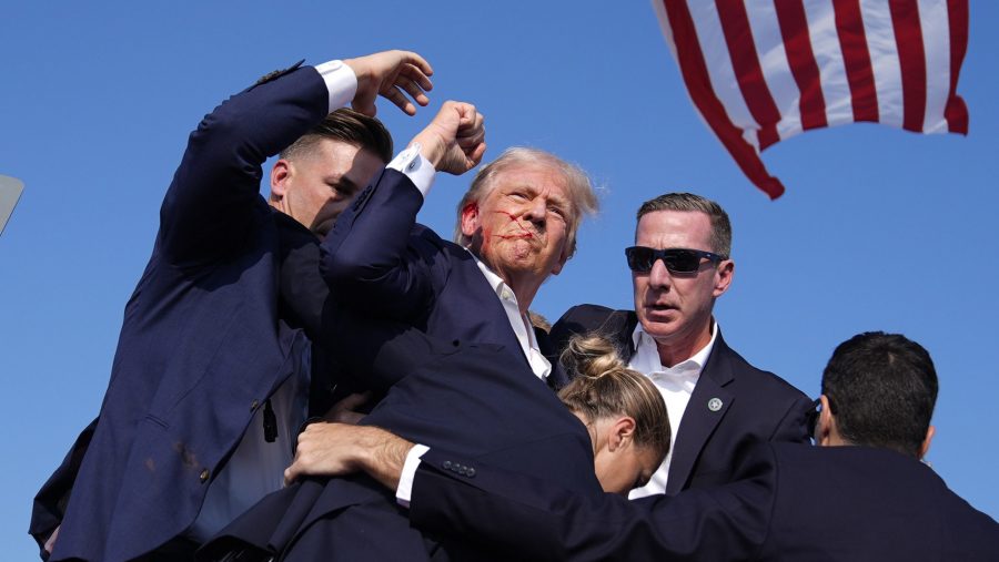 Republican presidential candidate former President Donald Trump is surround by U.S. Secret Service agents at a campaign rally, Saturday, July 13, 2024, in Butler, Pa.