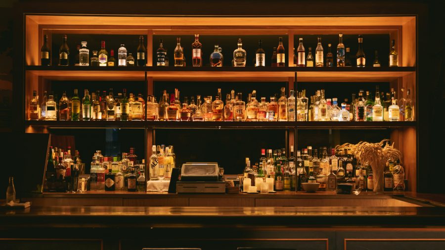 A bar with shelves of liquor bottles.