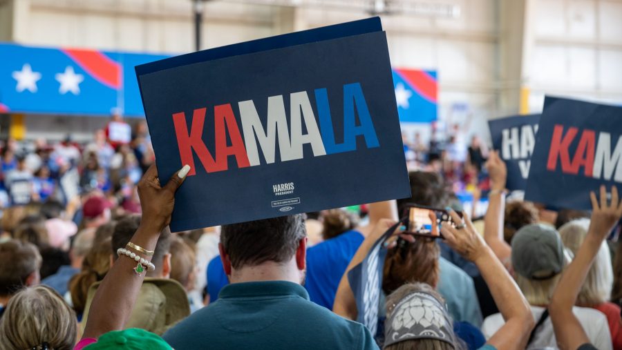 A Kamala Harris supporter holds up a sign during a Harris-Walz campaign rally at Detroit Metro Airport in Romulus on Wednesday, Aug. 7, 2024.