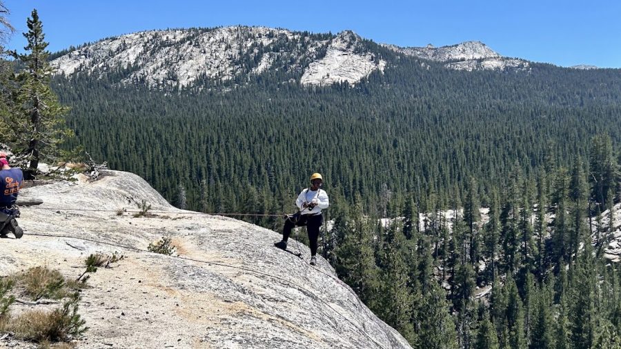 WDET reporter Sascha Raiyn stands on a mountain at Yosemite National Park.