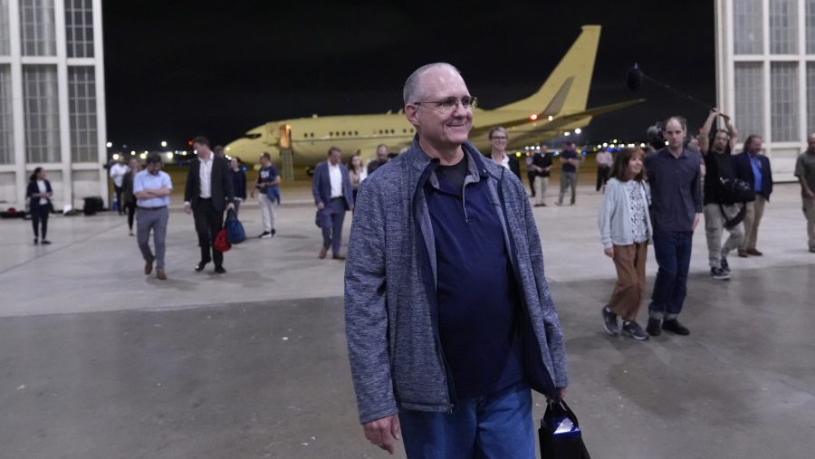 Paul Whelan, center, arrives at Kelly Field with Alsu Kurmasheva and Evan Gershkovich after being released by Russia, Friday, Aug. 2, 2024, in San Antonio.