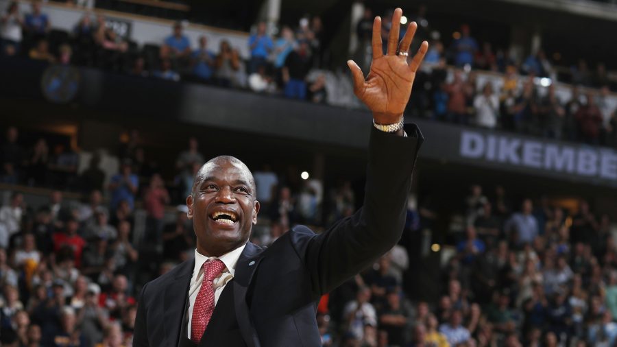 Retired Denver Nuggets center Dikembe Mutombo waves to the crowd as his jersey number was retired by the team during halftime of the Nuggets' NBA basketball game against the Portland Trail Blazers on Saturday, Oct. 29, 2016, in Denver.