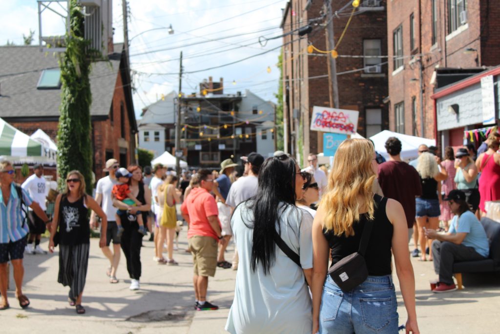 People stroll through Dally in the Alley