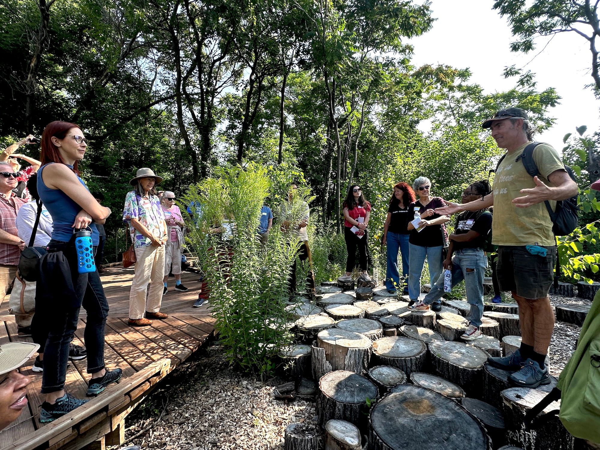 Kemp addresses Circle Forest visitors from the “stumpscape,” one of many native restoration projects led by Arboretum Detroit in the reclaimed space.