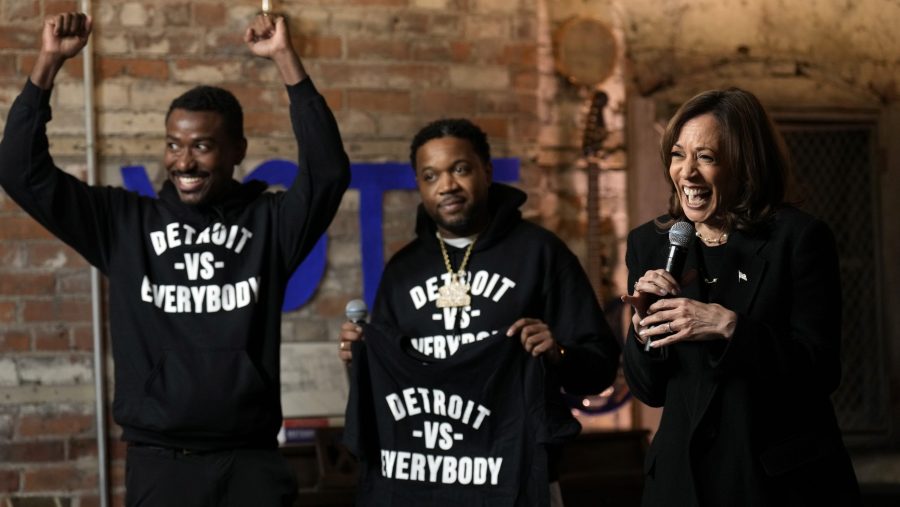 Democratic presidential nominee Vice President Kamala Harris speaks as Detroit vs Everybody co-founders Sean Xavier Williams, left, and Tommey Walker, listen, during a stop at Cred Cafe, a local Detroit small business owned by former NBA players Joe and Jamal Crawford, in Detroit, Tuesday, Oct. 15, 2024.