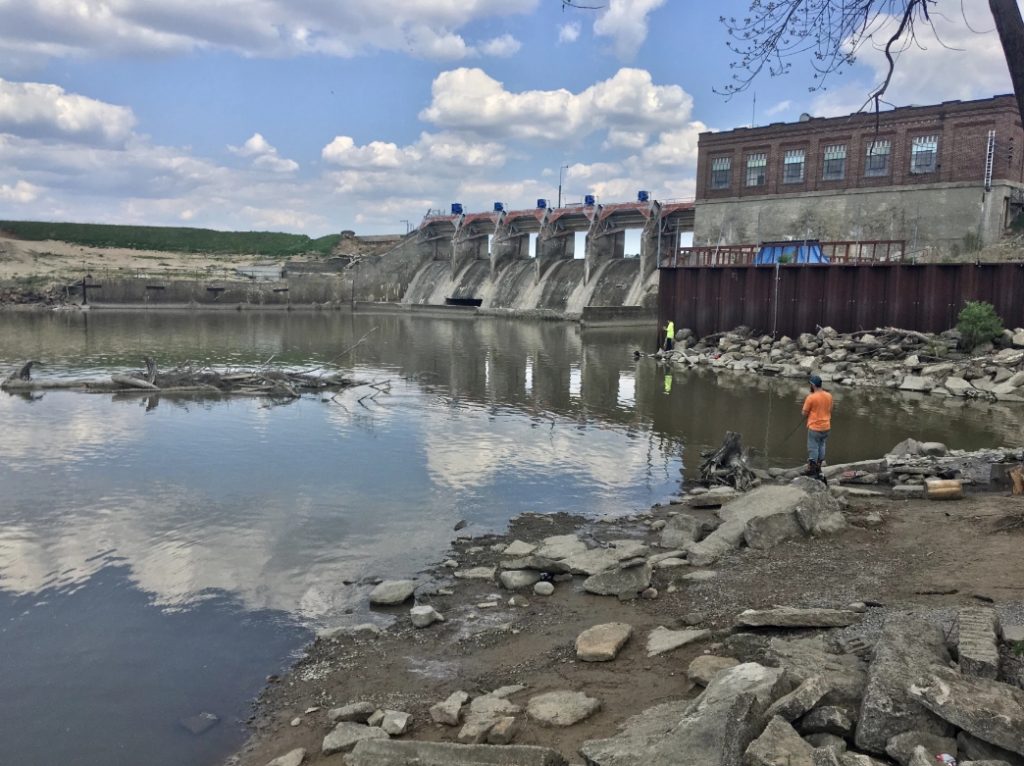 The Tittabawassee River no longer flows over the Sanford Dam after a flood damaged the dam in 2020. Now, the river flows around the embankment and pools at its bottom.