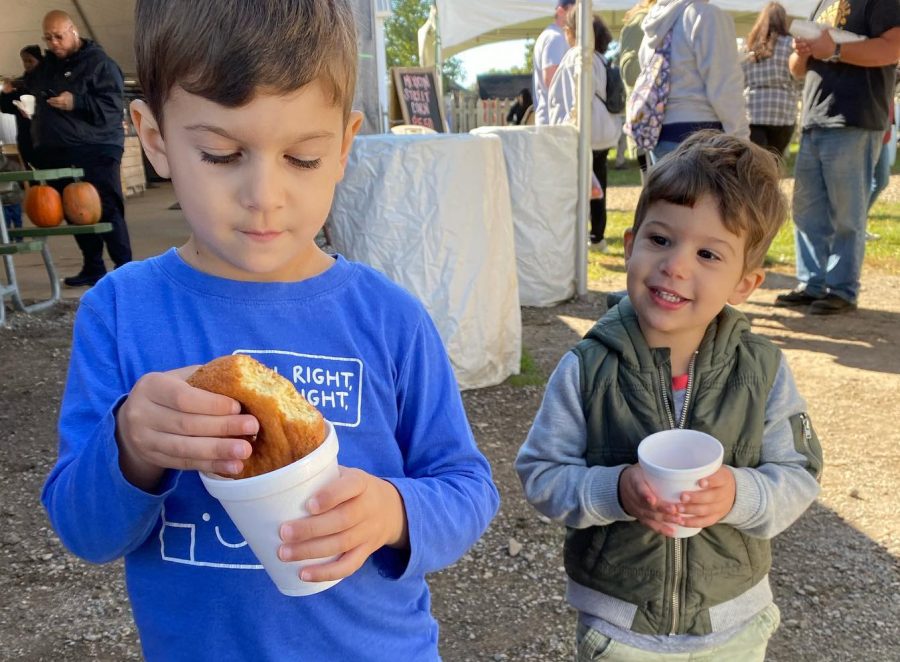 (From left) Milo Sherman, 4, and Theodore Sherman, 2, enjoy cider and doughnuts at Blake's Orchard & Cider Mill in Armada, Mich.