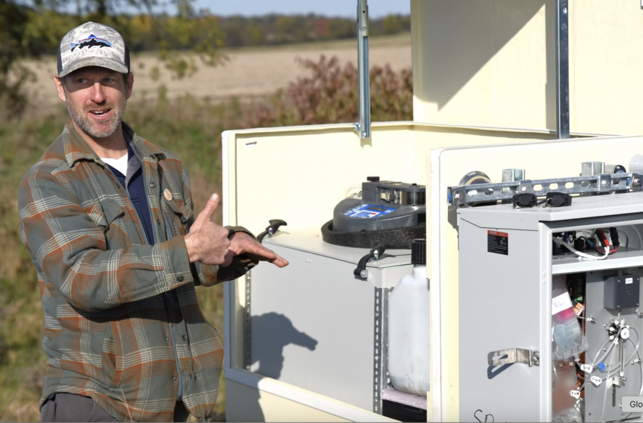 Ed Verhamme of LimnoTech and Freeboard Technology explains the multiple functions of one of the pieces of monitoring equipment at one of 50 sites in Michigan's Lake Erie watershed. Verhamme is also working with H2Ohio in its wetland monitoring program.