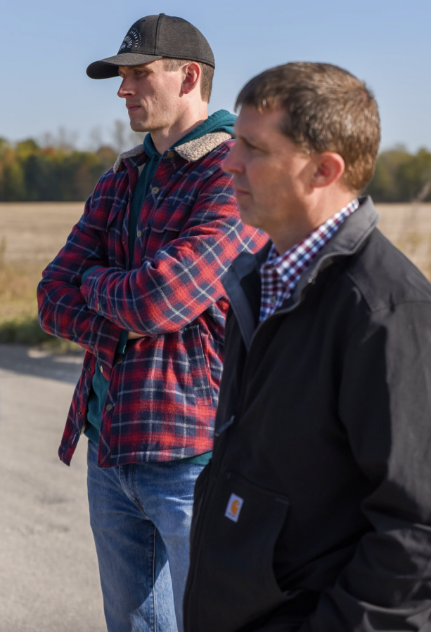 Tom Zimnicki, Agriculture and Restoration Policy Director with the Alliance for the Great Lakes (L) and Director of the Michigan Department of Agriculture and Rural Development Tim Boring (R) listen as the the abilities of stream monitoring equipment are explained.