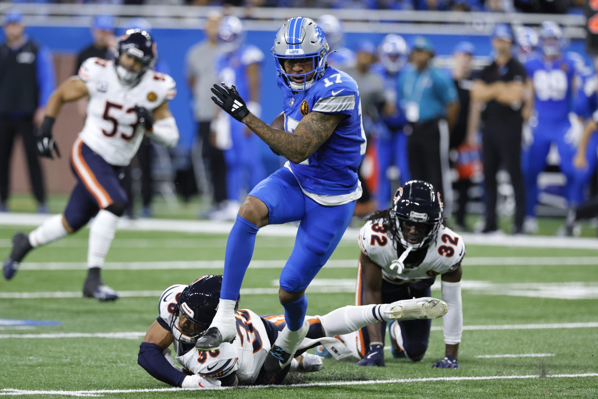 Detroit Lions wide receiver Tim Patrick (17) escapes the tackle of Chicago Bears safety Jonathan Owens (36) during the first half of an NFL football game, Sunday, Nov. 17, 2024, in Detroit.