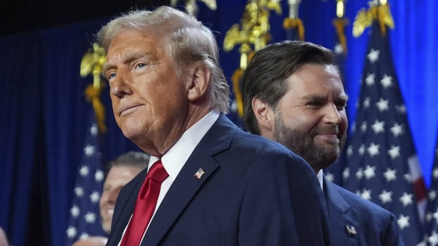 Republican presidential nominee former President Donald Trump and his running mate Sen. JD Vance, R-Ohio, stand on stage at an election night watch party at the Palm Beach Convention Center, Wednesday, Nov. 6, 2024, in West Palm Beach, Fla.