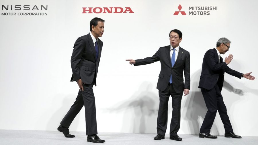 Nissan Chief Executive Makoto Uchida, left, Takao Kato, CEO of Mitsubishi Motors, center, and Honda Chief Executive Toshihiro Mibe, right, leave after a joint news conference in Tokyo, Japan, Monday, Dec. 23, 2024.