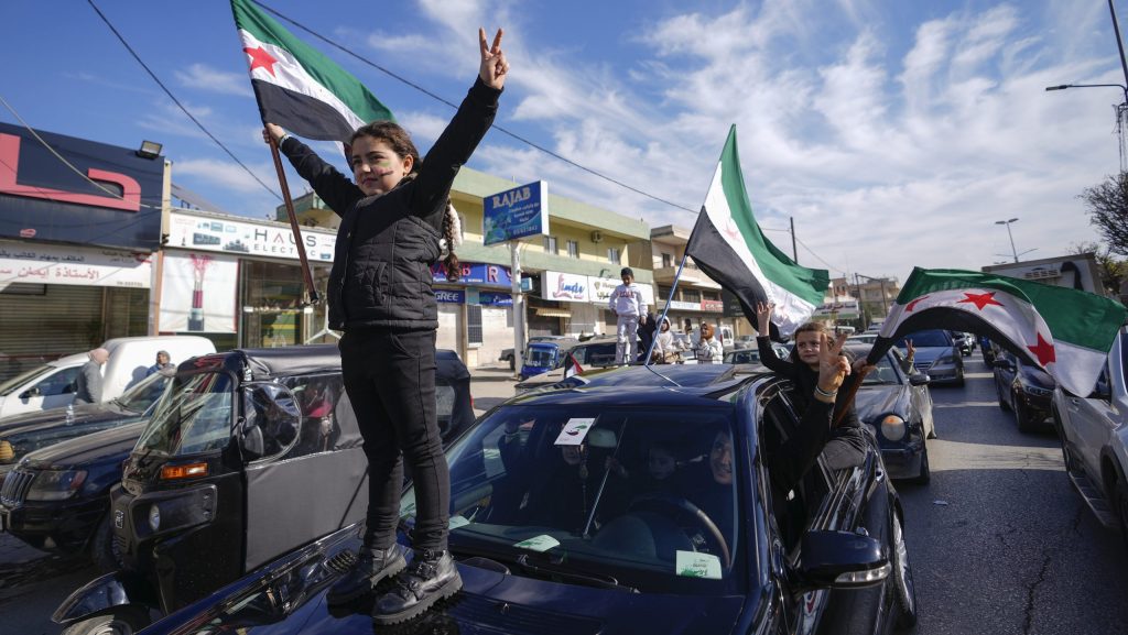 Syrians celebrate the fall of Bashar Assad's government in the town of Bar Elias, Lebanon, near the border with Syria, Sunday, Dec. 8, 2024.