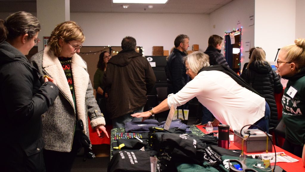 Visitors shop vintage WDET merch at Noel Night 2023.