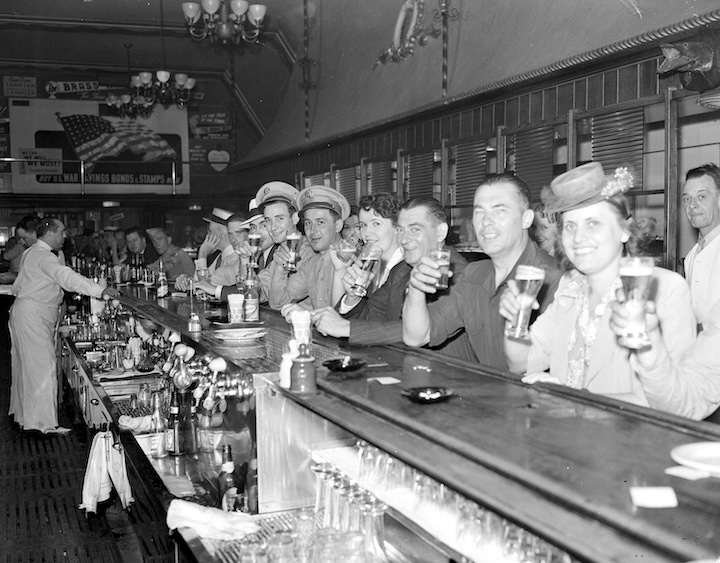 Bar patrons raise a glass at The Brass Rail, once considered "Detroit's longest bar," in 1943.