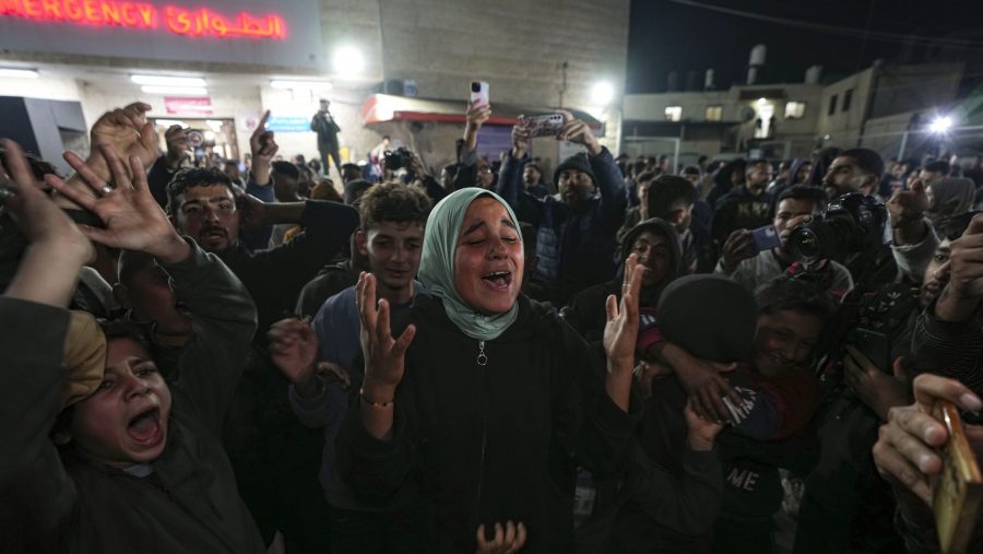 Palestinians celebrate the announcement of a ceasefire deal between Hamas and Israel in Deir al-Balah, central Gaza Strip, Wednesday, Jan. 15, 2025.