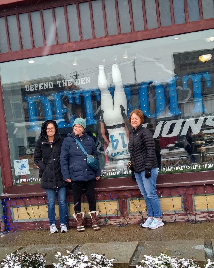 Visitors to The Home Bakery in Rochester pose for a photo with the life-sized cake replica of Detroit Lions receiver Amon-Ra St. Brown.