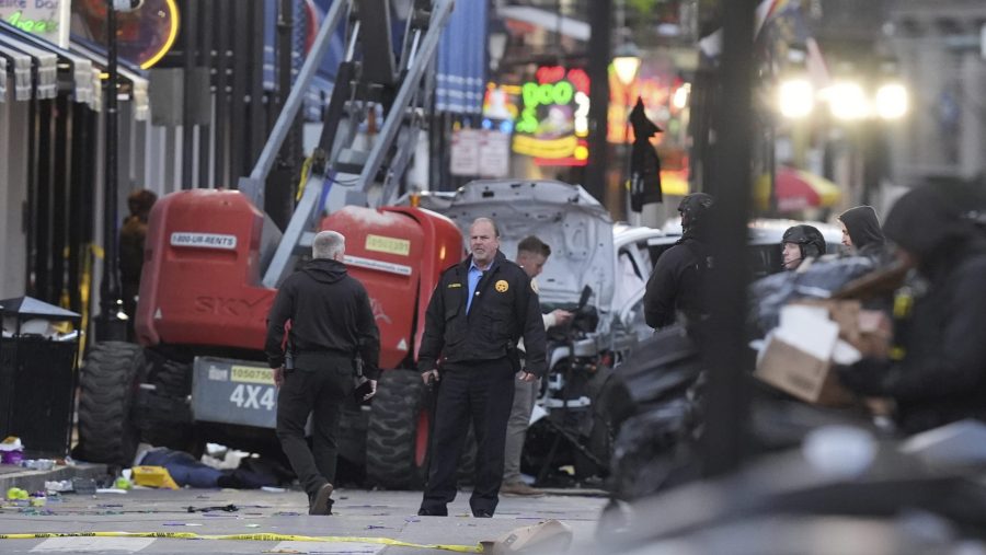 Security personnel investigate the scene on Bourbon Street after a vehicle drove into a crowd on New Orleans' Canal and Bourbon Street, Wednesday Jan. 1, 2025.