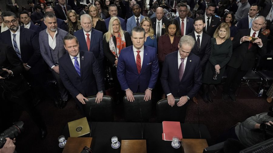 Pete Hegseth, center, President-elect Donald Trump's choice to be Defense secretary, arrives to appear before the Senate Armed Services Committee for his confirmation hearing, at the Capitol in Washington, Tuesday, Jan. 14, 2025.