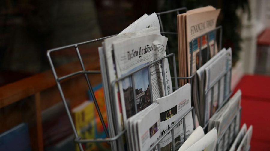 Newspapers on a metal rack