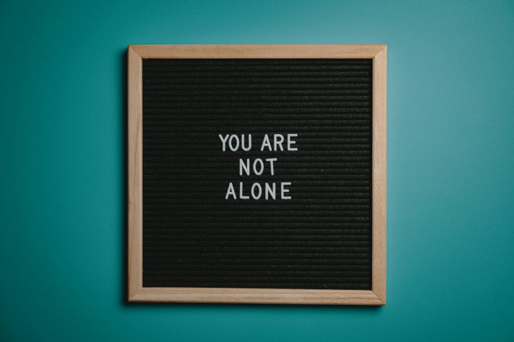 A sign reads "You are not alone"