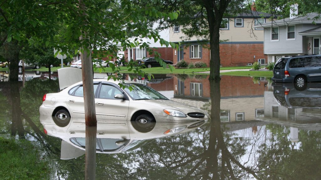 A car is stuck in a flooded street in the Ecorse Creek watershed in Dearborn Heights.