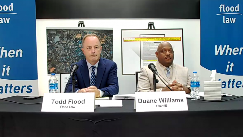 Attorney Todd Flood (left) joins Duane Williams in announcing a $100 million lawsuit against the city of Detroit for Williams' wrongful conviction in 2013.