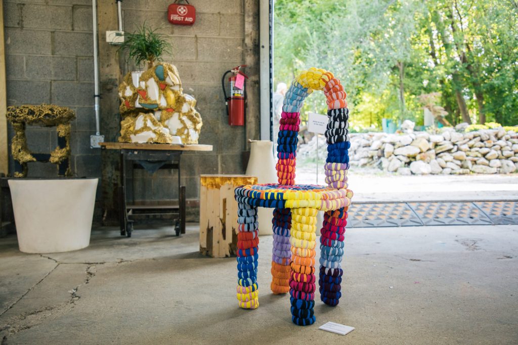 3D art piece, shaped like a chair with a texture reminiscent of a piñata.
