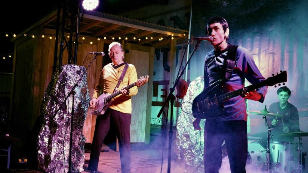 A band performs onstage wearing Star Trek costumes